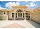Inviting front of the home features a tile roof, arched entry, and decorative accents at 3577 Maribella Dr, New Smyrna Beach, FL 32168