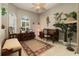 The home office is decorated with dark wood furniture, area rugs, and parrot themed wall art at 3577 Maribella Dr, New Smyrna Beach, FL 32168