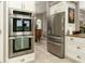 Kitchen featuring modern stainless steel appliances, white cabinets, and stone countertops at 3577 Maribella Dr, New Smyrna Beach, FL 32168