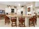Bright kitchen with counter seating, stone countertops, stainless appliances, and ample storage at 3577 Maribella Dr, New Smyrna Beach, FL 32168