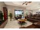 Spacious living room featuring a leather sofa, stone accent wall, and sliding doors to the outdoor patio at 3577 Maribella Dr, New Smyrna Beach, FL 32168
