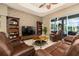 Open living room with leather furniture, tile floors, and a stacked stone accent wall offers a spacious environment at 3577 Maribella Dr, New Smyrna Beach, FL 32168