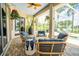 Spacious screened patio includes comfortable seating, ceiling fan, and tropical accents at 3577 Maribella Dr, New Smyrna Beach, FL 32168