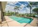 Sparkling screened-in pool area with lush landscaping and serene lake views at 3577 Maribella Dr, New Smyrna Beach, FL 32168