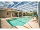 Backyard pool and patio with a screened enclosure and tile roofing at 3577 Maribella Dr, New Smyrna Beach, FL 32168