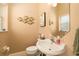 Charming powder room with decorative mirror, pedestal sink, and stylish decor at 3577 Maribella Dr, New Smyrna Beach, FL 32168