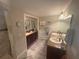 Bathroom featuring double sinks, dark wood cabinets, and a separate tiled shower area at 38 Cedar Dunes Dr, New Smyrna Beach, FL 32169