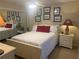 Bedroom featuring a queen bed with white linens, decorative pillows, and matching nightstands at 38 Cedar Dunes Dr, New Smyrna Beach, FL 32169
