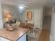 Bright dining area with round table, white chairs, and decorative accents, adjacent to the stairway at 38 Cedar Dunes Dr, New Smyrna Beach, FL 32169