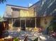 Exterior view of a bright patio area with colorful seating, an upper balcony and an enclosed sunroom at 38 Cedar Dunes Dr, New Smyrna Beach, FL 32169
