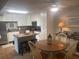 Well-lit kitchen with white cabinets, stainless steel appliances, and adjacent dining area at 38 Cedar Dunes Dr, New Smyrna Beach, FL 32169