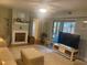 Spacious living room with a fireplace, plush seating, and natural light at 38 Cedar Dunes Dr, New Smyrna Beach, FL 32169
