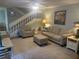 Cozy living room with comfortable seating, soft lighting, and staircase access at 38 Cedar Dunes Dr, New Smyrna Beach, FL 32169