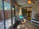 Screened-in porch with brick flooring, outdoor seating, and access to the kitchen through sliding glass doors at 38 Cedar Dunes Dr, New Smyrna Beach, FL 32169