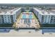 Expansive aerial view of beachfront condos featuring beautifully landscaped grounds and dual sparkling swimming pools at 4151 S Atlantic Ave # 3090, New Smyrna Beach, FL 32169