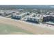 Aerial shot of the beachfront community with buildings, pools, and direct beach access at 4151 S Atlantic Ave # 3090, New Smyrna Beach, FL 32169