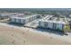 Drone view capturing beachfront condos with a pool, beach access, and meticulously maintained landscaping at 4151 S Atlantic Ave # 3090, New Smyrna Beach, FL 32169