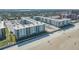 Aerial view of beachfront condo community with pool, shuffleboard court, and direct access to pristine sandy beach at 4151 S Atlantic Ave # 3090, New Smyrna Beach, FL 32169
