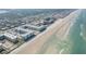 Panoramic aerial view showcasing beachfront properties, ocean, and a vibrant coastal landscape at 4151 S Atlantic Ave # 3090, New Smyrna Beach, FL 32169