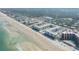 Expansive aerial view of a beachfront condo community with pools, beaches, and lush surroundings at 4151 S Atlantic Ave # 3090, New Smyrna Beach, FL 32169