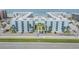Aerial view of condominium complex featuring manicured landscaping, a pool, on the beach, and ample parking at 4151 S Atlantic Ave # 3090, New Smyrna Beach, FL 32169