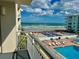 Balcony overlooking the ocean, pool, and shuffleboard, perfect for relaxing and enjoying the scenery at 4151 S Atlantic Ave # 3090, New Smyrna Beach, FL 32169