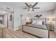 Open concept bedroom has a large window, a ceiling fan, and access to an ensuite bathroom at 4151 S Atlantic Ave # 3090, New Smyrna Beach, FL 32169