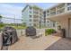 Outdoor grilling area features well-maintained grills, adjacent to lush landscaping, ideal for community gatherings at 4151 S Atlantic Ave # 3090, New Smyrna Beach, FL 32169