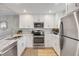 Modern kitchen with stainless steel appliances, marble countertops, and ample cabinet space at 4151 S Atlantic Ave # 3090, New Smyrna Beach, FL 32169