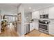 Modern kitchen with stainless steel appliances, marble countertops, and an open view to the living area at 4151 S Atlantic Ave # 3090, New Smyrna Beach, FL 32169