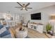 Open-concept living room boasts modern furnishings, an indoor dining area, and breakfast bar seating at 4151 S Atlantic Ave # 3090, New Smyrna Beach, FL 32169