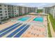 Community featuring two swimming pools, shuffleboard courts, and many poolside lounge chairs at 4151 S Atlantic Ave # 3090, New Smyrna Beach, FL 32169