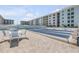 A charming condo community features shuffleboard, tables, and seating near the pool area at 4151 S Atlantic Ave # 3090, New Smyrna Beach, FL 32169