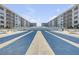 Community shuffleboard court surrounded by resort buildings providing a recreational amenity for residents at 4151 S Atlantic Ave # 3090, New Smyrna Beach, FL 32169