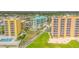 Panoramic aerial view of the condominium complex, neighboring buildings, and lush greenery at 423 S Atlantic Ave # 301, New Smyrna Beach, FL 32169