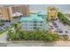 Aerial view of the home in a coastal community near the beach, surrounding palm trees, and parking at 423 S Atlantic Ave # 301, New Smyrna Beach, FL 32169