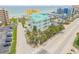 Stunning aerial view of a mint green condominium complex with a metal roof by the ocean at 423 S Atlantic Ave # 301, New Smyrna Beach, FL 32169