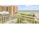 Balcony view overlooking lush landscaping and the beach at 423 S Atlantic Ave # 301, New Smyrna Beach, FL 32169