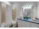 Stylish bathroom featuring blue accents, decorative tile, and a shower-tub combo at 423 S Atlantic Ave # 301, New Smyrna Beach, FL 32169