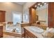 Well-lit bathroom featuring a soaking tub and a frosted window at 423 S Atlantic Ave # 301, New Smyrna Beach, FL 32169