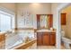 Bright bathroom with a soaking tub and tile surround at 423 S Atlantic Ave # 301, New Smyrna Beach, FL 32169