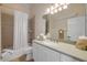 Bright bathroom with a shower-tub combo, neutral tile, and a white single sink vanity at 423 S Atlantic Ave # 301, New Smyrna Beach, FL 32169