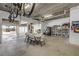 Large garage space with white walls, storage shelves, and room for a table and chairs at 423 S Atlantic Ave # 301, New Smyrna Beach, FL 32169