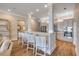 Open-concept kitchen with breakfast bar, modern appliances, tile backsplash, and wooden floors at 423 S Atlantic Ave # 301, New Smyrna Beach, FL 32169