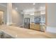 Bright, modern kitchen with stainless steel refrigerator, attractive cabinets, and backsplash at 423 S Atlantic Ave # 301, New Smyrna Beach, FL 32169