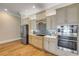 Beautiful kitchen with stainless steel appliances, custom cabinets, tile backsplash, and wooden floors at 423 S Atlantic Ave # 301, New Smyrna Beach, FL 32169