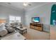 Inviting living room featuring soft seating, a ceiling fan, and a mounted television at 423 S Atlantic Ave # 301, New Smyrna Beach, FL 32169