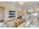 Open-concept living room with fireplace, stone accent wall, and view to kitchen at 423 S Atlantic Ave # 301, New Smyrna Beach, FL 32169