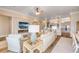 Open-concept living room with fireplace, stone accent wall, and view to kitchen at 423 S Atlantic Ave # 301, New Smyrna Beach, FL 32169