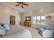Comfortable main bedroom with natural light, ceiling fan, and walk-in bathroom at 423 S Atlantic Ave # 301, New Smyrna Beach, FL 32169